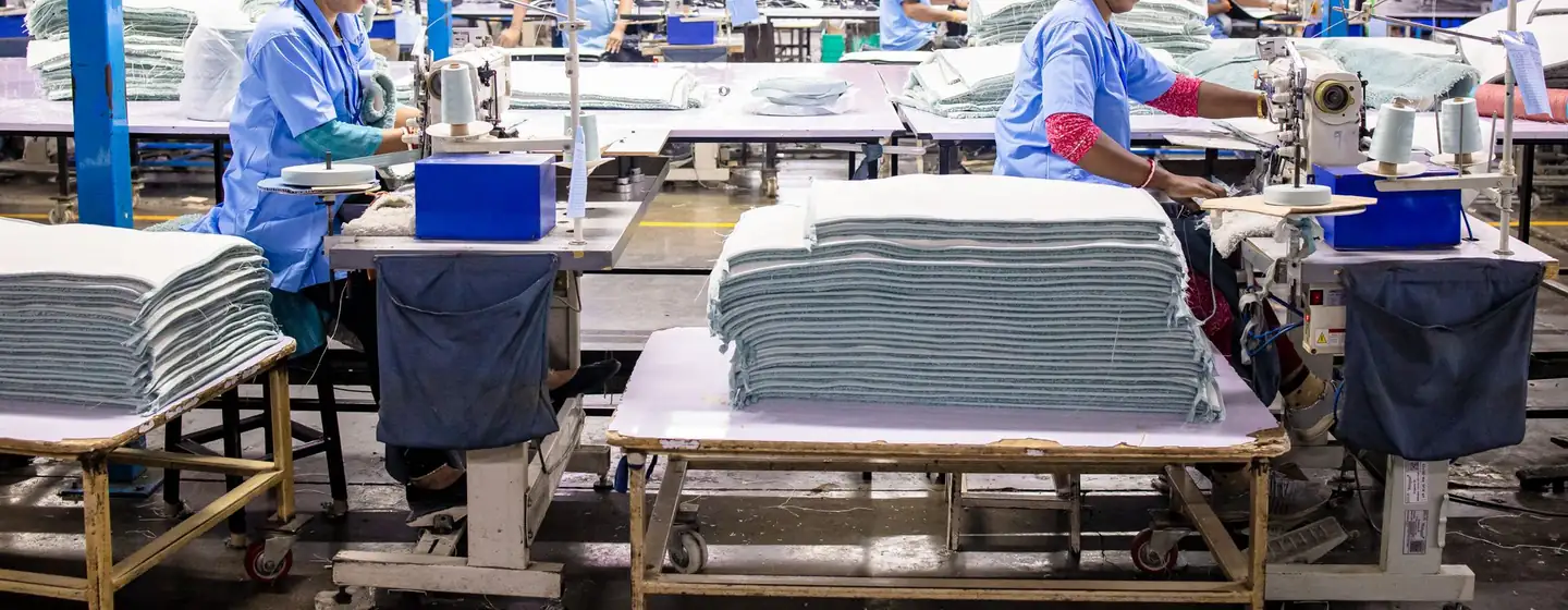 Sewing line of operators and industrial machines in a garment factory