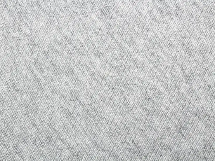 Close-up of grey heather cotton knit, the smooth face of French terry hoodie fabric