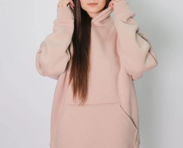 Pink oversized hoodie with dropped shoulders and a large kangaroo pocket from an oversized hoodie manufacturer
