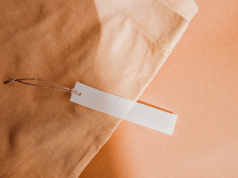 Blank hang tag on garment fabric, ready for private label branding